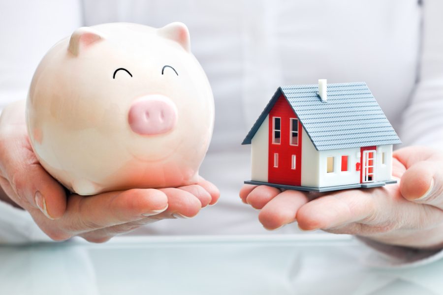 Estate Planning Lawyer - Hands holding a piggy bank and a house model