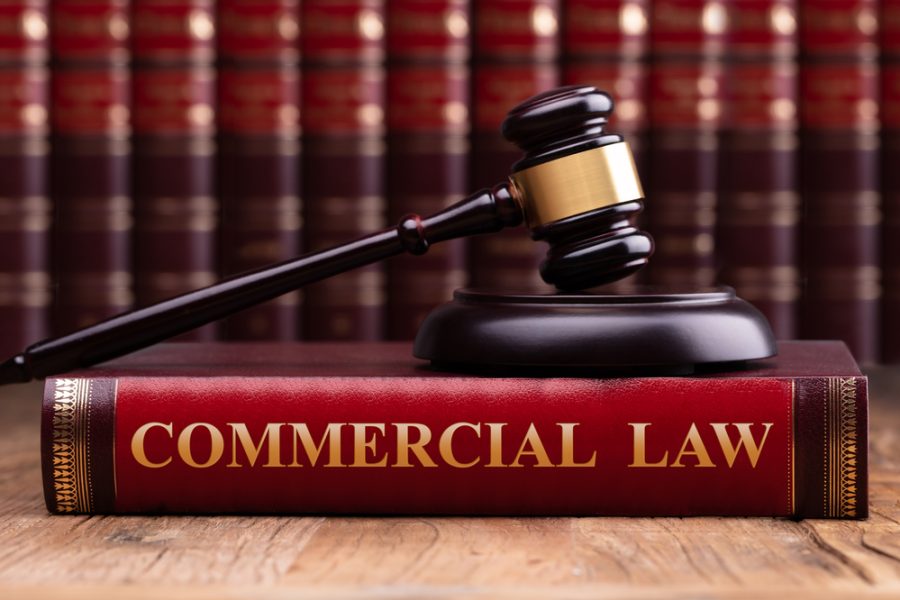 What Makes a Good Commercial Litigation Lawyer - Gavel And Striking Block Over Commercial Law Book On Desk