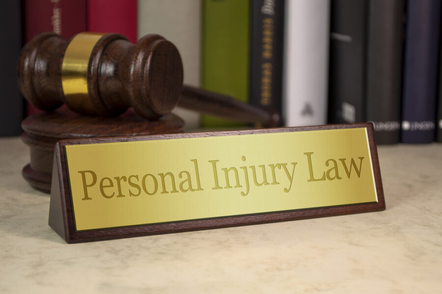 Hiring An Accident Lawyer Vs The Car Insurance Company - legal books gavel and desk name card